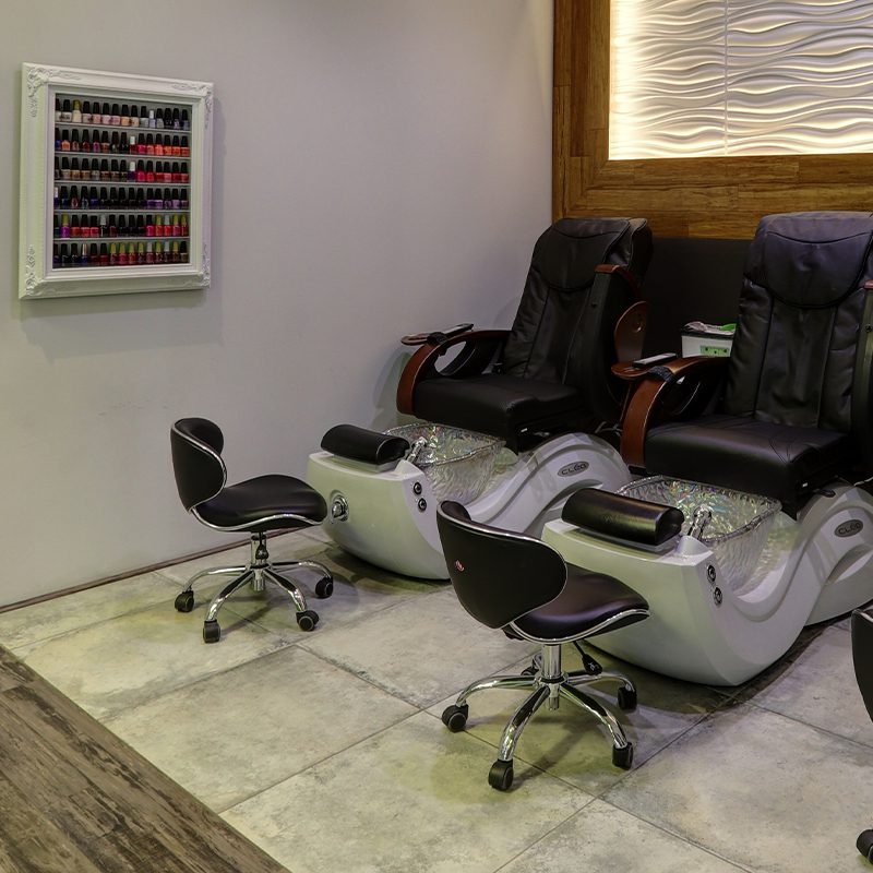 A room with two black chairs and three white chairs