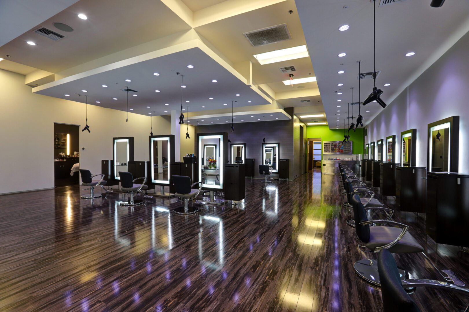 A hair salon with many chairs and mirrors