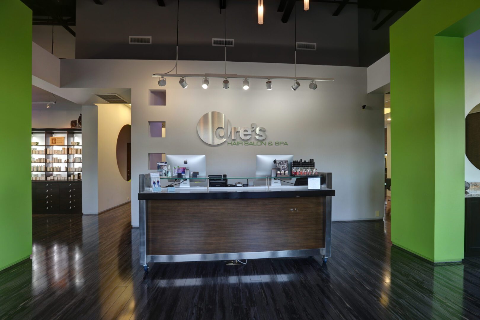 A reception desk in an office setting with wood floors.